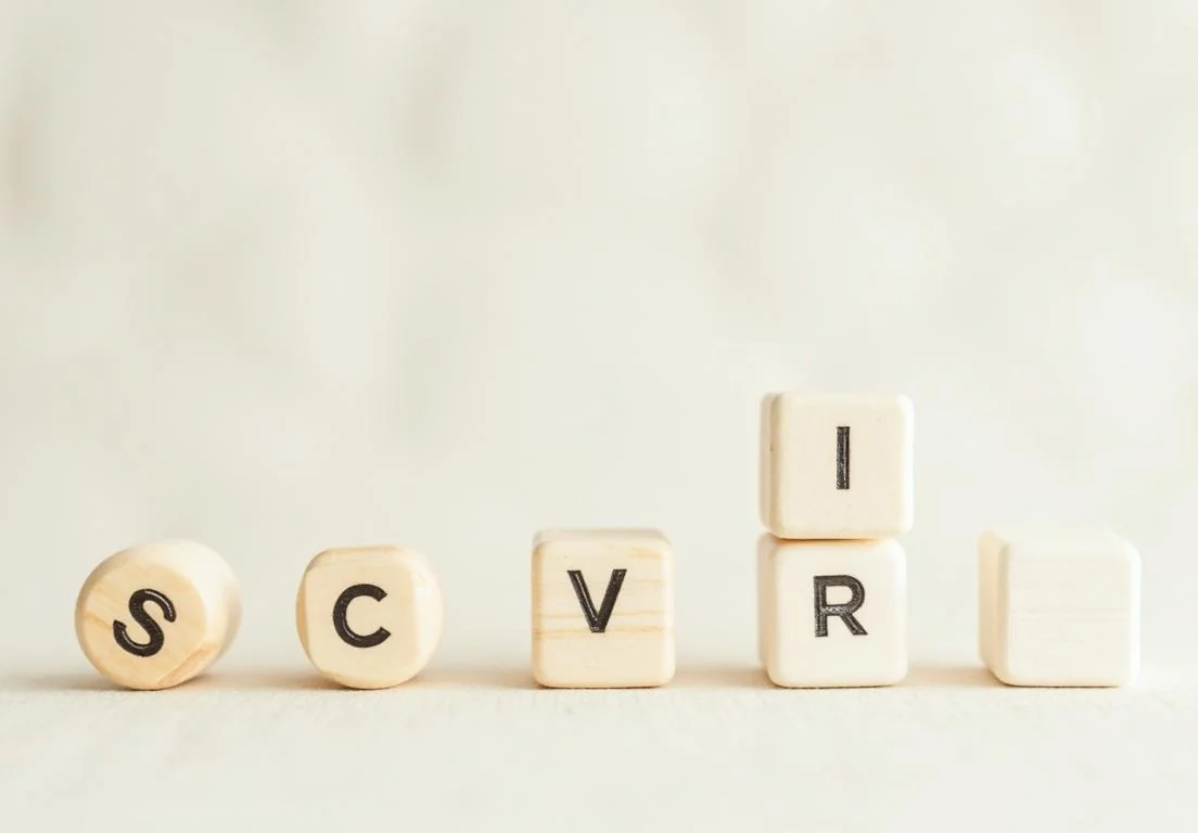 a wooden block with the word cvr spelled in black on top of it